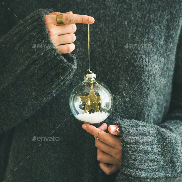 Woman in grey sweater holding decorative glass ball, square crop - Stock Photo - Images