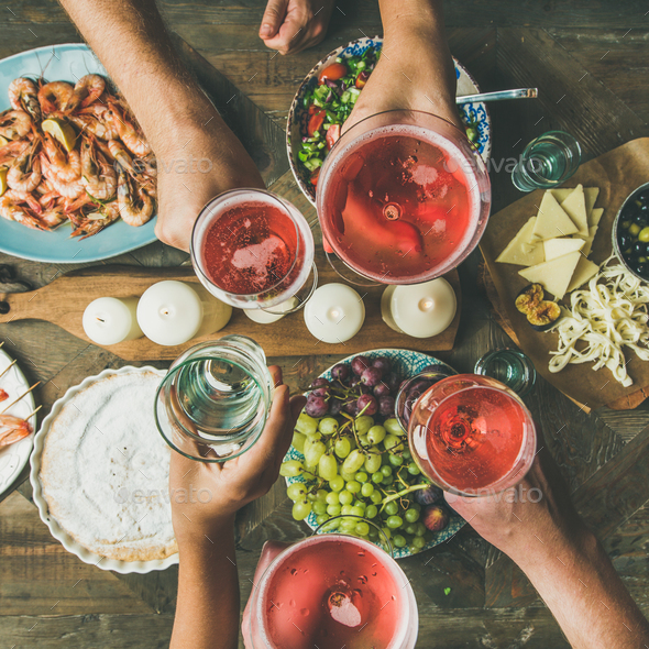 Flat-lay of friends hands eating and drinking together, square crop - Stock Photo - Images