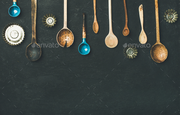 Flat-lay of old vintage kitchen spoons and baking tin molds - Stock Photo - Images