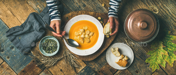 Fall warming pumpkin cream soup, top view, wide composition - Stock Photo - Images