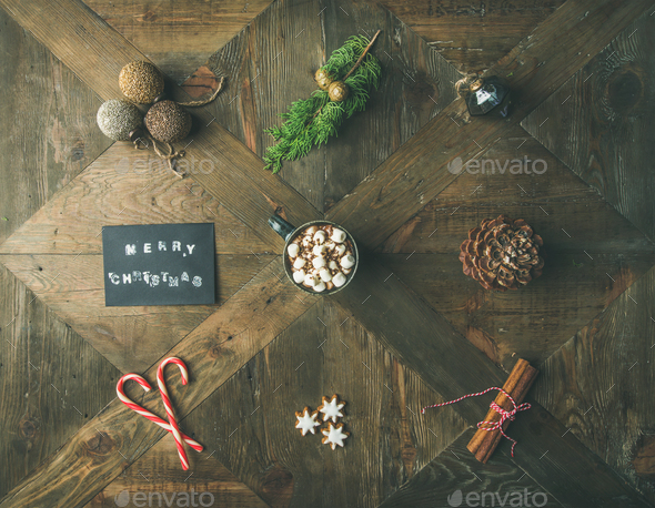 Flat-lay of greeting card, hot chocolate, candy cane, pine cone - Stock Photo - Images