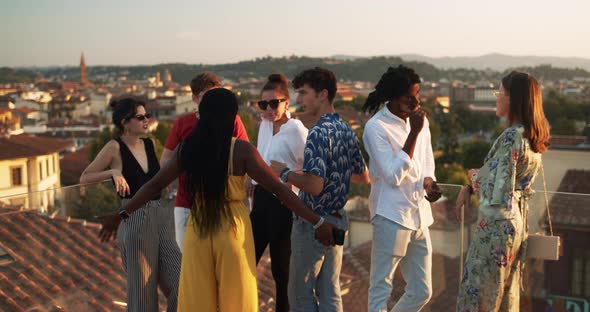 Young group of students during a party at sunset