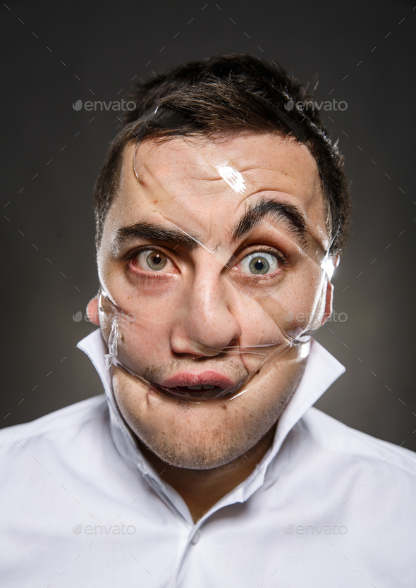 Studio portrait of funny scotch taped man face