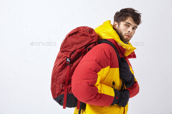 Mountaineer in winter clothes with hiking equipment on white isolated background