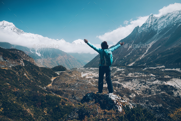 Landscape with happy girl, mountains, blue sky with clouds - Stock Photo - Images