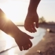 Two Lovers Joining Hands near the Sunset Lake - VideoHive Item for Sale
