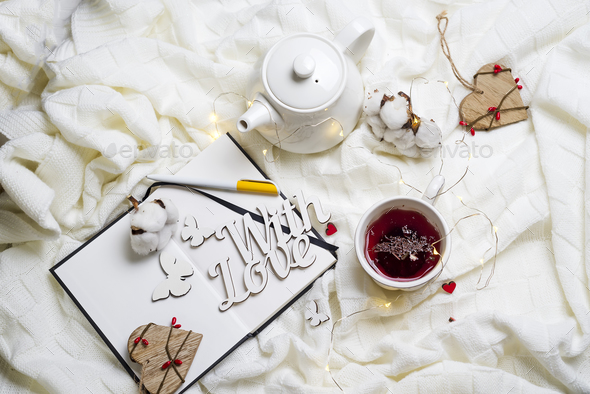 Warm knitted plaid,cup of hot tea and notebook - Stock Photo - Images