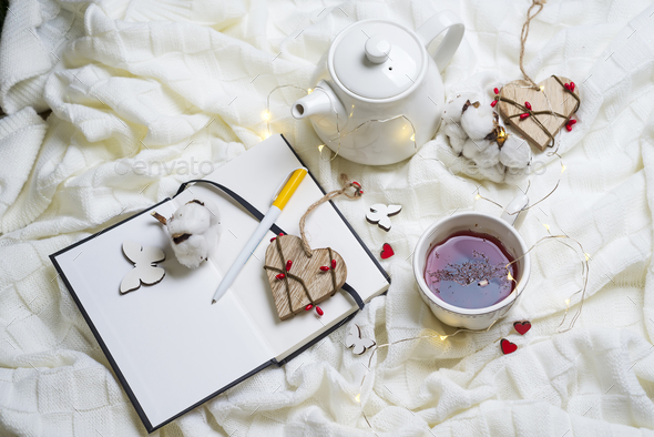 Warm knitted plaid,cup of hot tea and notebook - Stock Photo - Images