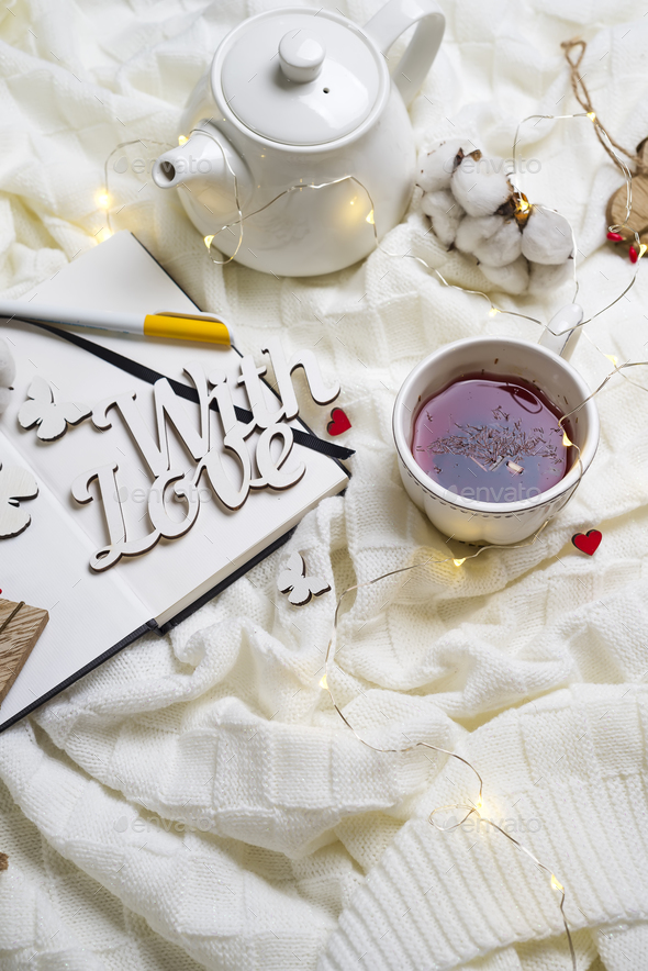 Warm knitted plaid,cup of hot tea and notebook - Stock Photo - Images
