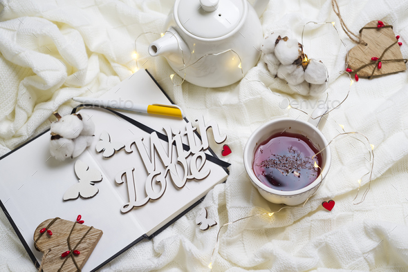 Warm knitted plaid,cup of hot tea and notebook - Stock Photo - Images