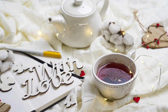 Warm knitted plaid,cup of hot tea and notebook - Stock Photo - Images
