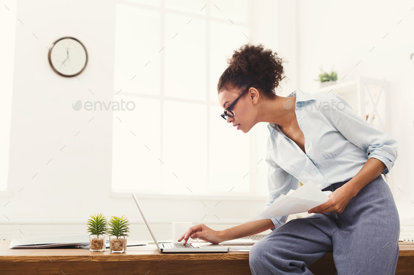 Business woman working with documents at office desktop - Stock Photo - Images