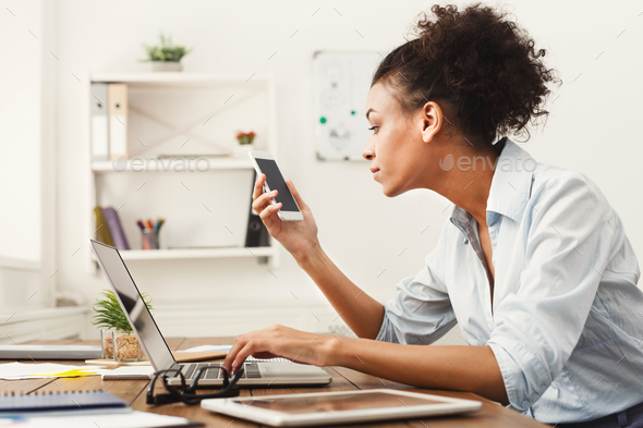 Business woman looking at smartphone - Stock Photo - Images