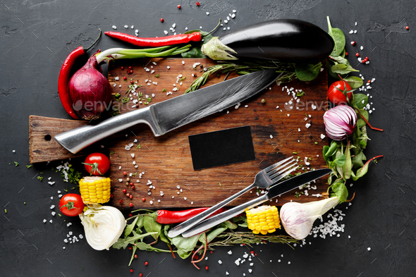 Wooden desk with vegetables border on dark background - Stock Photo - Images