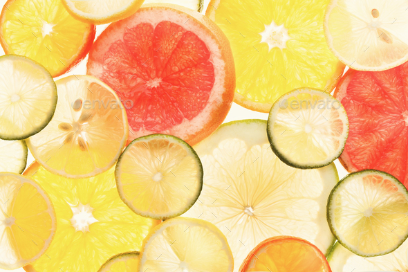 Backlit citrus fruits slices background - Stock Photo - Images