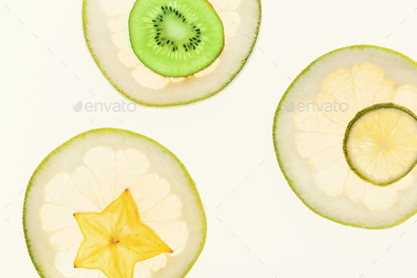 Backlit citrus fruits slices background - Stock Photo - Images