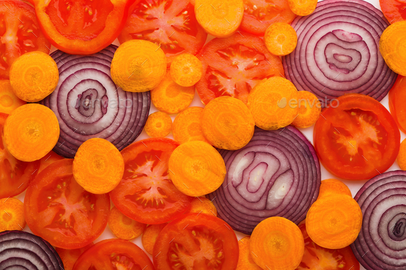 Colorful slices of tomatoes, carrots and onion - Stock Photo - Images