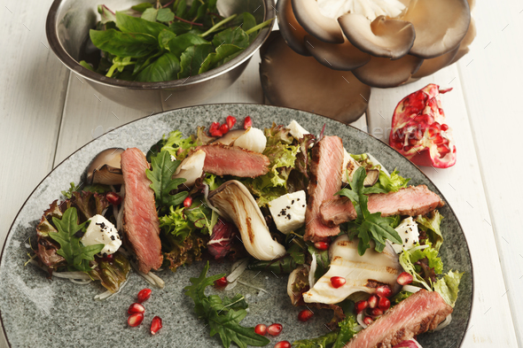 Warm mix salad with duck meat and mushrooms. Modern restaurant dish - Stock Photo - Images