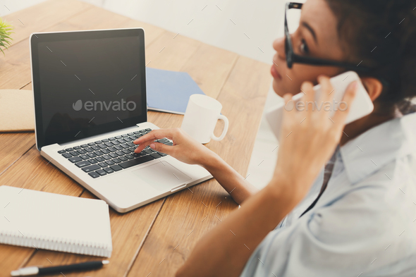Business woman using laptop with blank screen - Stock Photo - Images