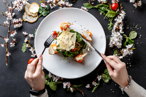 Eating restaurant dish on white plate on black background - Stock Photo - Images