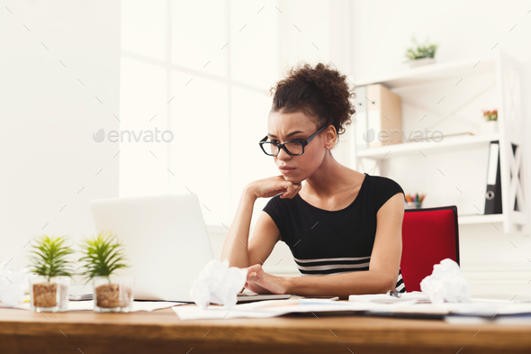 Serious business woman working on laptop at office - Stock Photo - Images