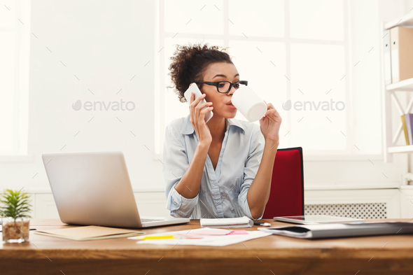 Business talk, woman consulting by phone at office - Stock Photo - Images