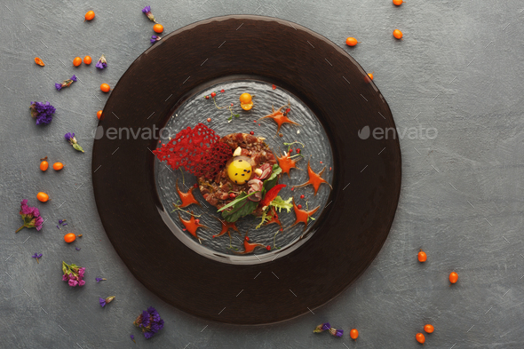 Modern restaurant dish. Veal tartare with quail egg closeup - Stock Photo - Images