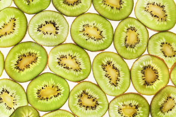 Backlit kiwifruit slices background - Stock Photo - Images