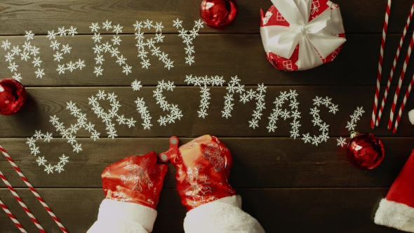 Santa Claus Plays with Spinner Toy By Wooden Christmas Table, Top Down Shot