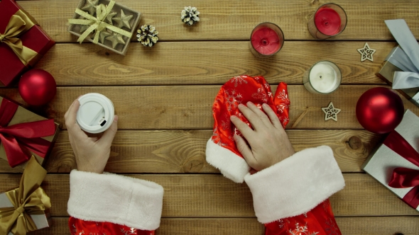 Santa Claus Drinks Coffee By New Year Wooden Table, Top Down Shot