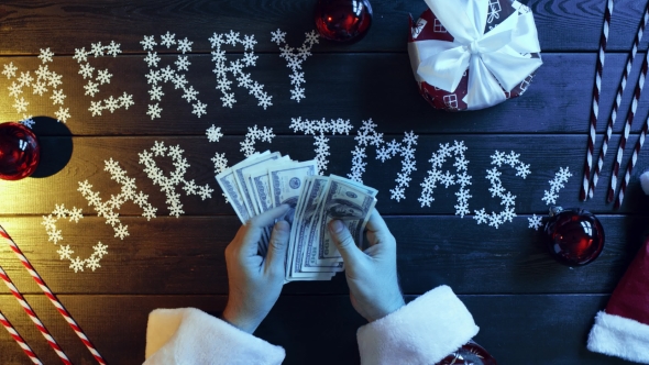 Santa Claus Counts Cash Money By New Year Decorated Table, Top Down Shot