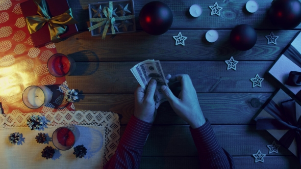 Man Counts Cash Money By New Year Decorated Table, Top Down Shot