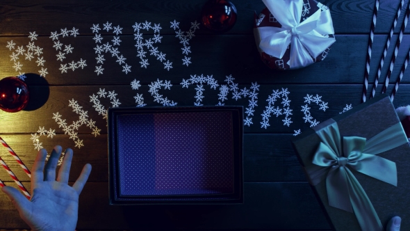 Man Opens Empty Xmas Present Box By Holiday Table, Top Down Shot