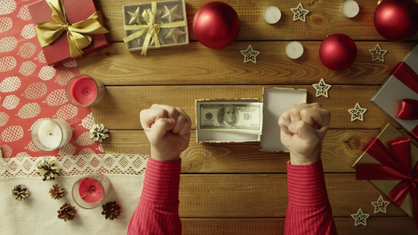 Man Opens Christmas Gift Box with Cash Money Inside, Top Down Shot