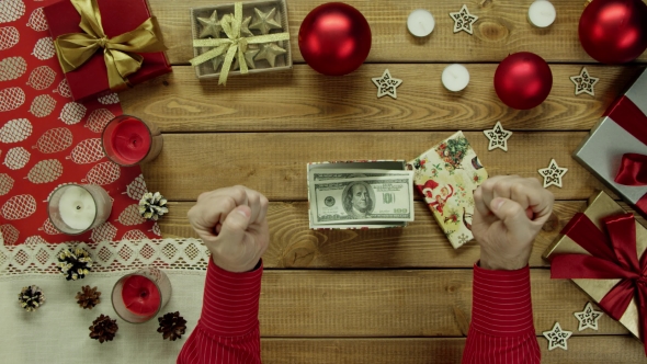 Man Unboxes Christmas Gift Box with Cash Money Inside, Top Down Shot