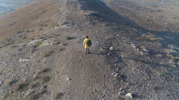 Aerial View Tourist Man Standing on the Mountain alt