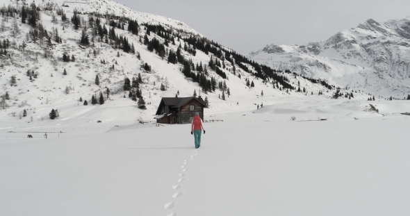 Woman Is Walking Towards Ski Lodge