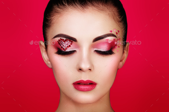 Face of beautiful woman with holiday makeup heart - Stock Photo - Images