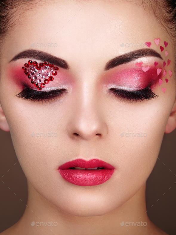 Face of beautiful woman with holiday makeup heart Stock Photo by  heckmannoleg