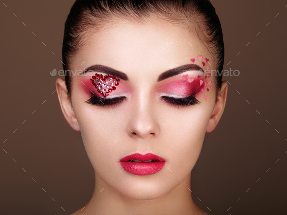 Face of beautiful woman with holiday makeup heart - Stock Photo - Images