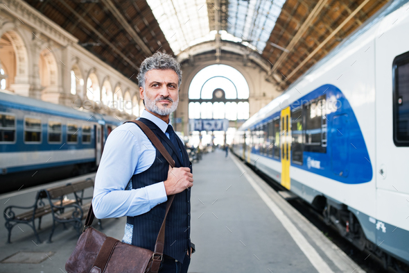 Mature businessman on a train station. Stock Photo by halfpoint | PhotoDune