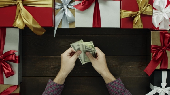 Adult Man Counts Dollars By New Year Decorated Table, Top Down