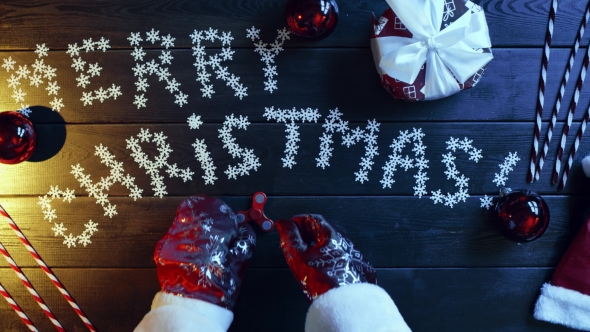 Santa Claus Plays with Spinner Toy By Wooden New Year Table, Top Down Shot