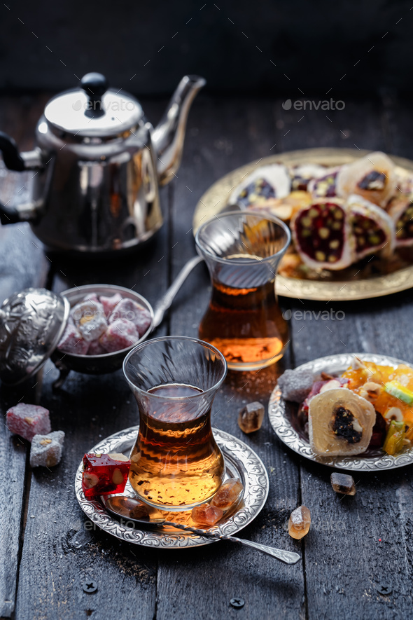 Tea in traditional turkish glasses with oriental delights and sweets