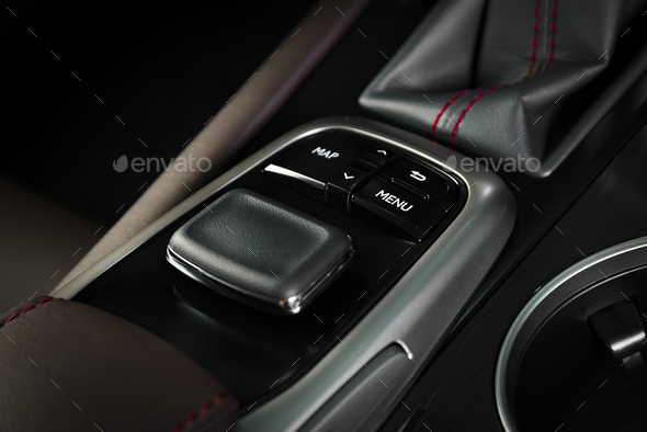 Navigation control button in modern car interior - Stock Photo - Images