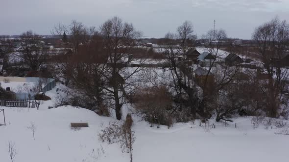 Old Wooden Houses in the Russian Village Covered with Snow