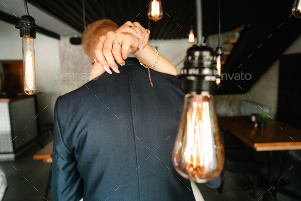 retro bulbs lights. newlyweds couple embracing - Stock Photo - Images