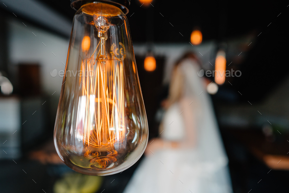 retro bulbs lights. newlyweds couple embracing - Stock Photo - Images