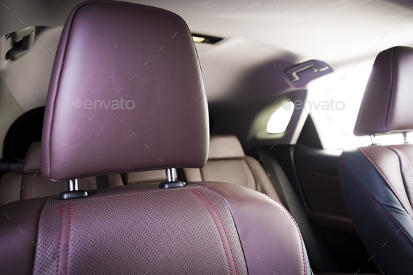 back seats of modern luxury car, red leather interior