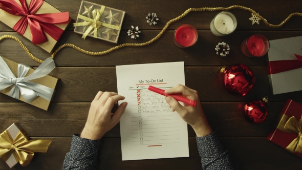 Adult Man Fills Up His To-do List Before Christmas, Top Down Shot